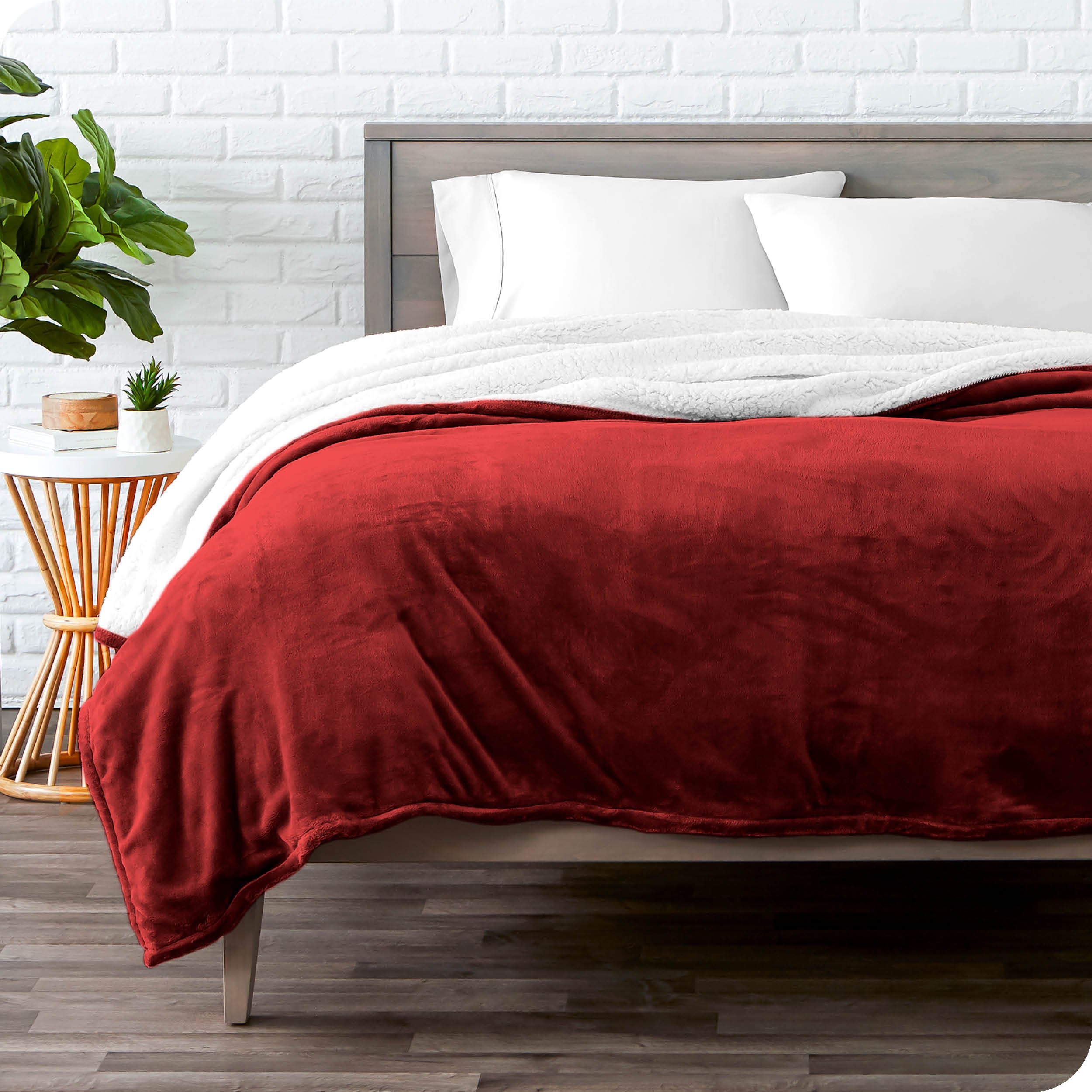Red Sherpa Blanket laying on a bed folded over itself part way