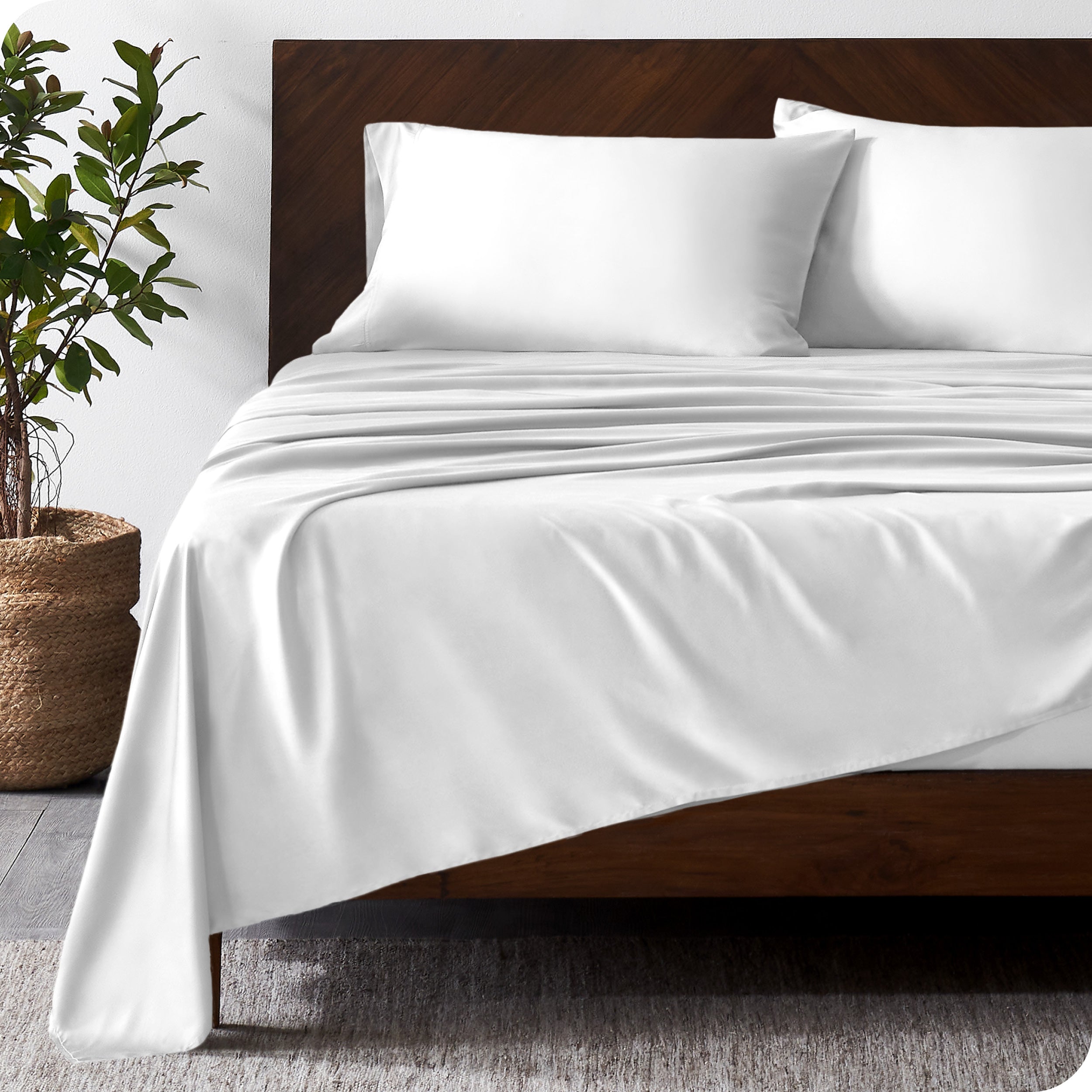 Wooden bed frame with bamboo sheets on the bed