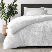 A white shaggy duvet cover on a bed