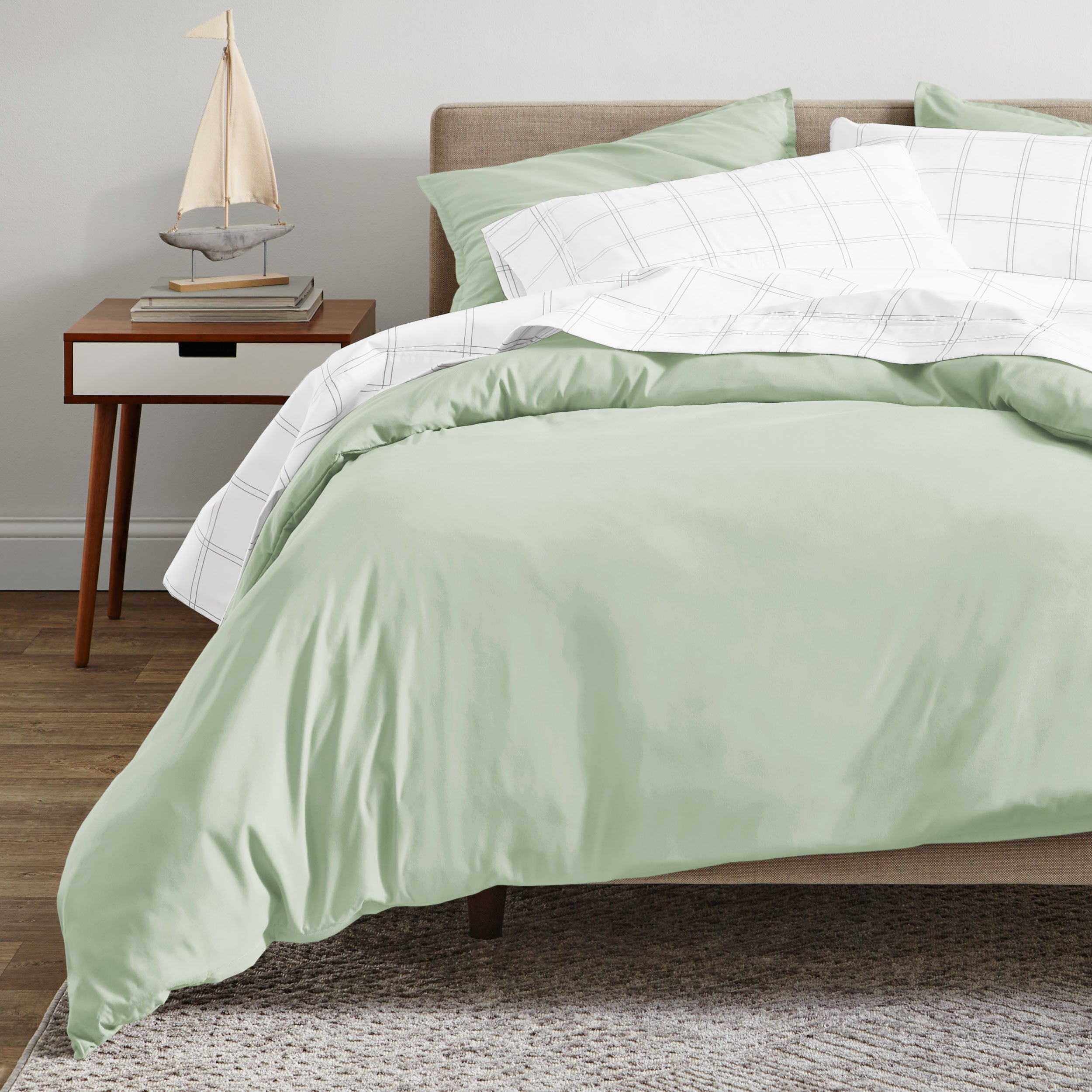 A modern bed with a organic sateen duvet cover set on.