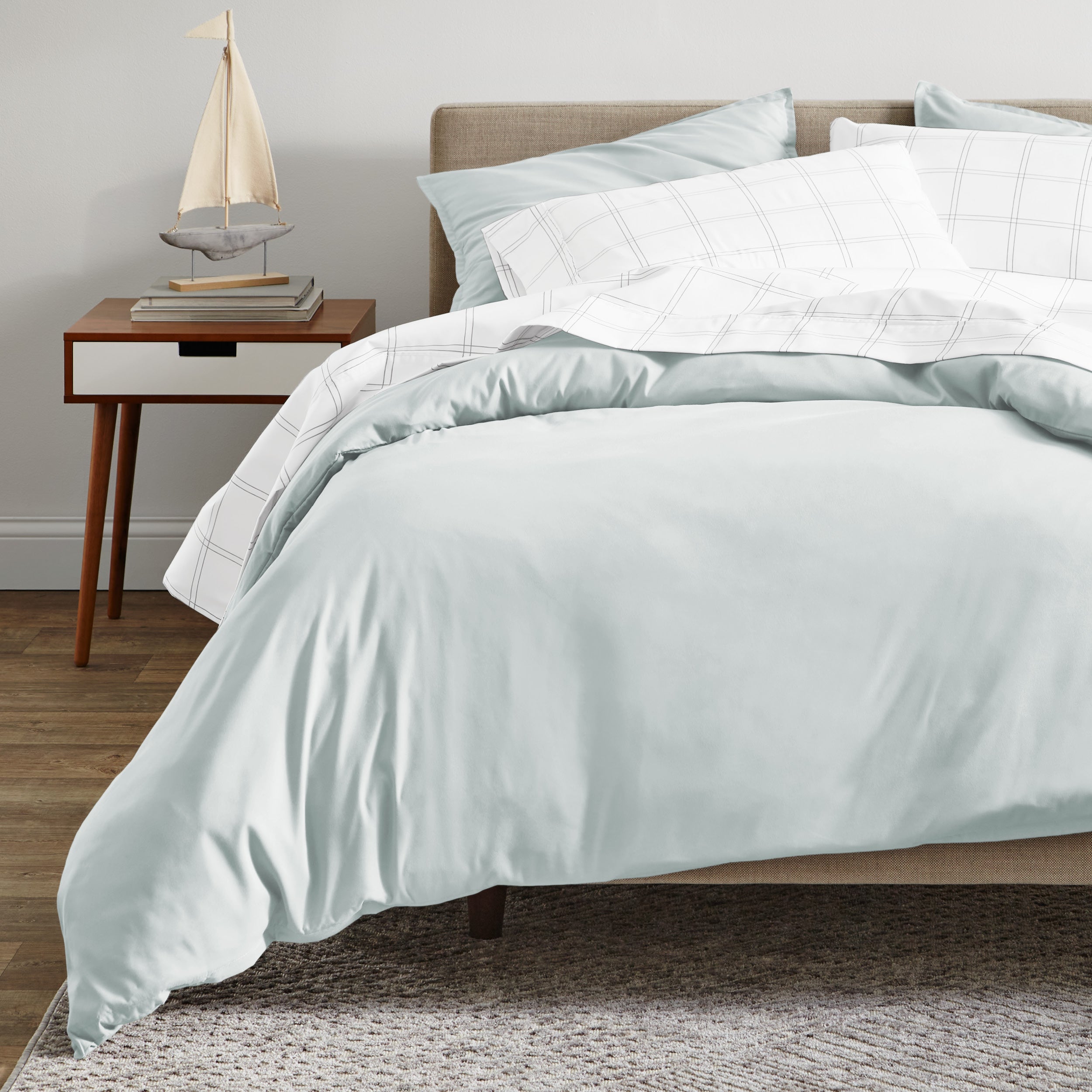 A modern bed with a organic sateen duvet cover set on.