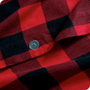A close up of the flannel duvet cover showing the button, lining, texture, and pattern.