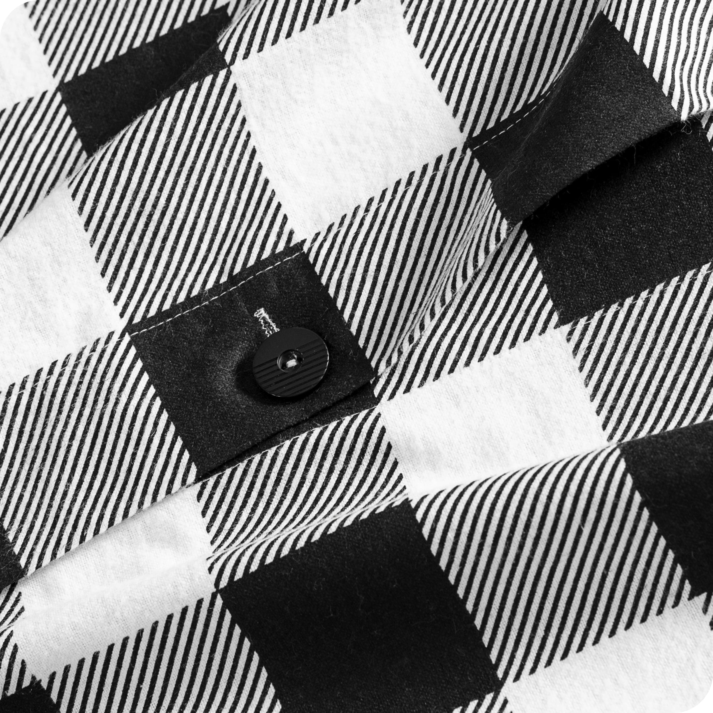 A close up of the flannel duvet cover showing the button, lining, texture, and pattern.