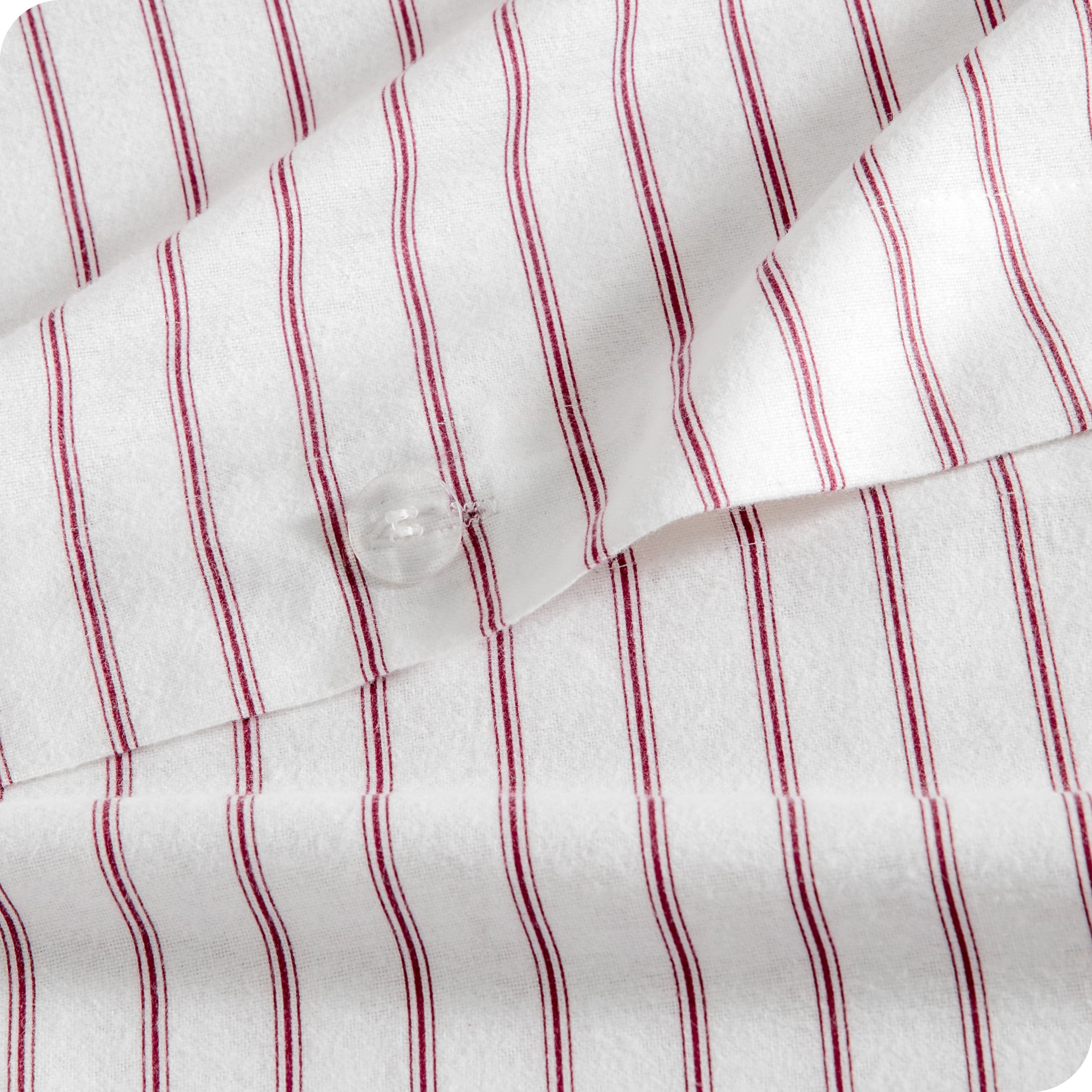 A close up of the flannel duvet cover showing the button, lining, texture, and pattern.