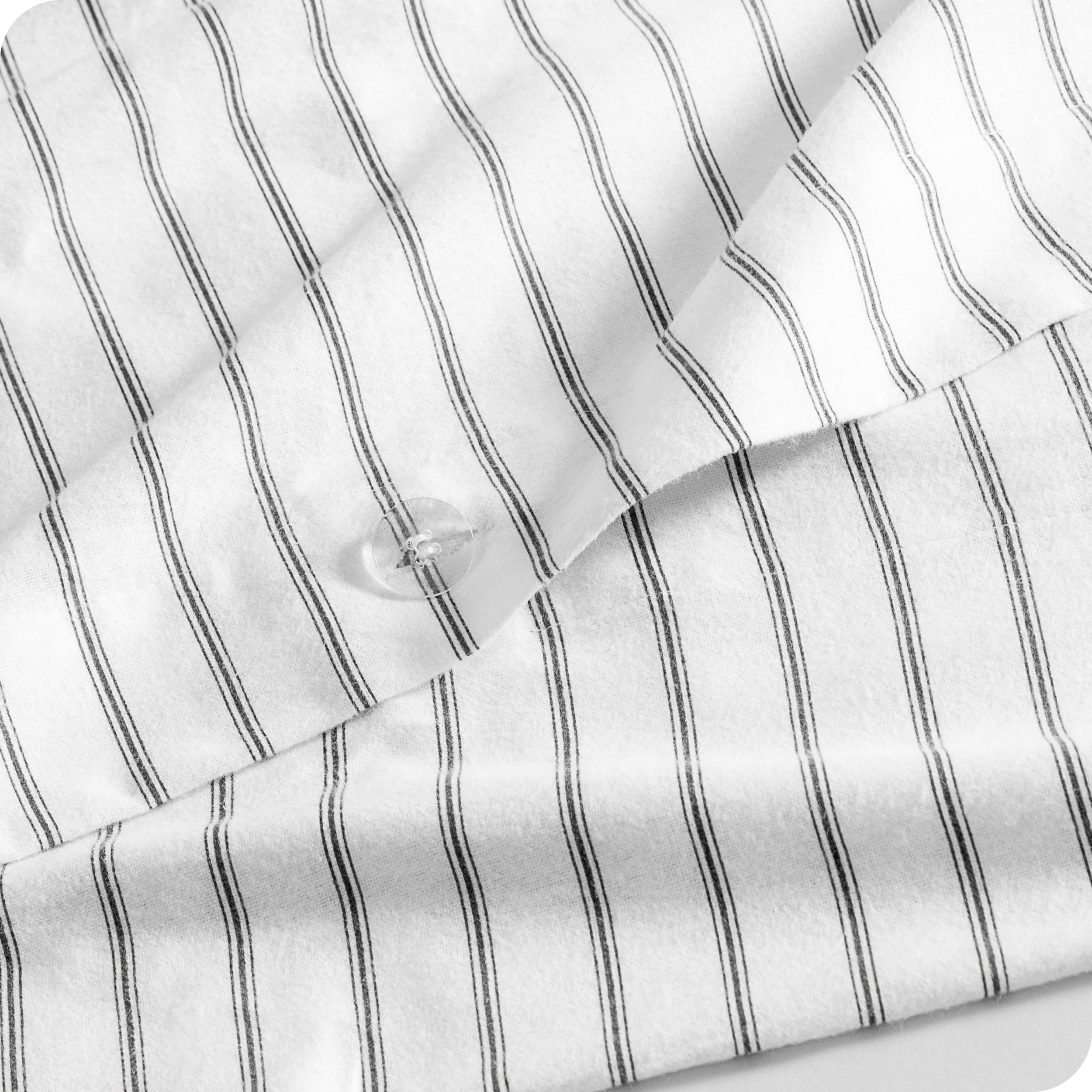 A close up of the flannel duvet cover showing the button, lining, texture, and pattern.